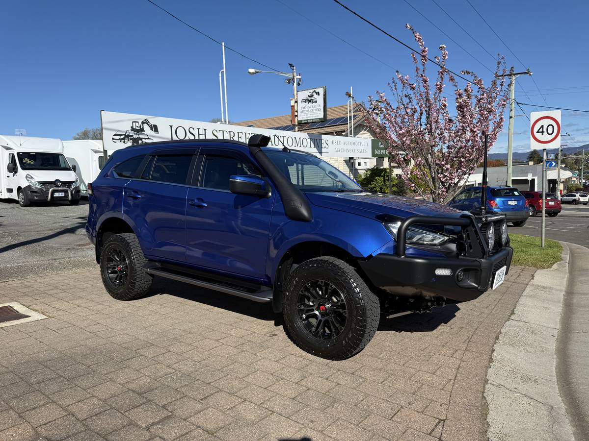 Blue Isuzu MU-X 4WD wagon with snorkel, bull bar and black alloy wheels, sold by Streets Automotives in Deloraine
